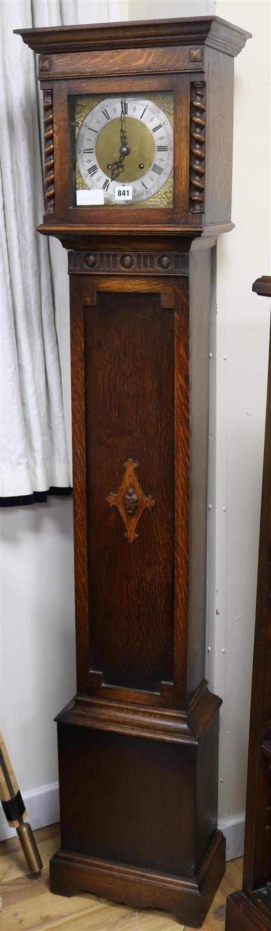 A Jacobean style oak cased eight day grandmother clock H.169cm